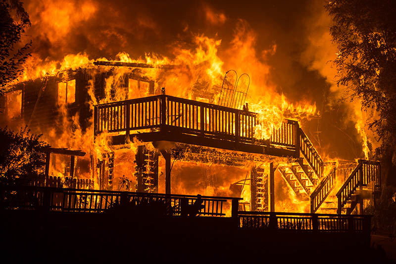 A home on fire during the CZU Lightning Complex wildfire in California.